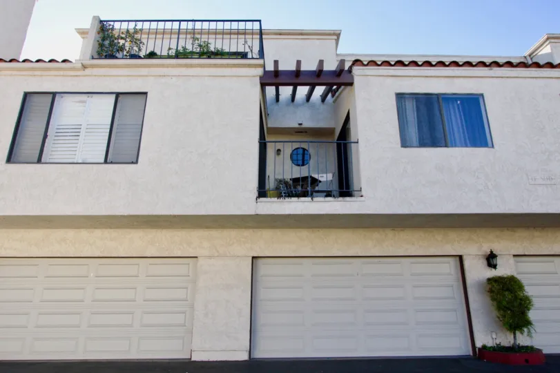 THE BUILDING IN THE VILLA GRANDE WITH THE BALCONI, SHUTTERS, PLANTS, FLOWER POT