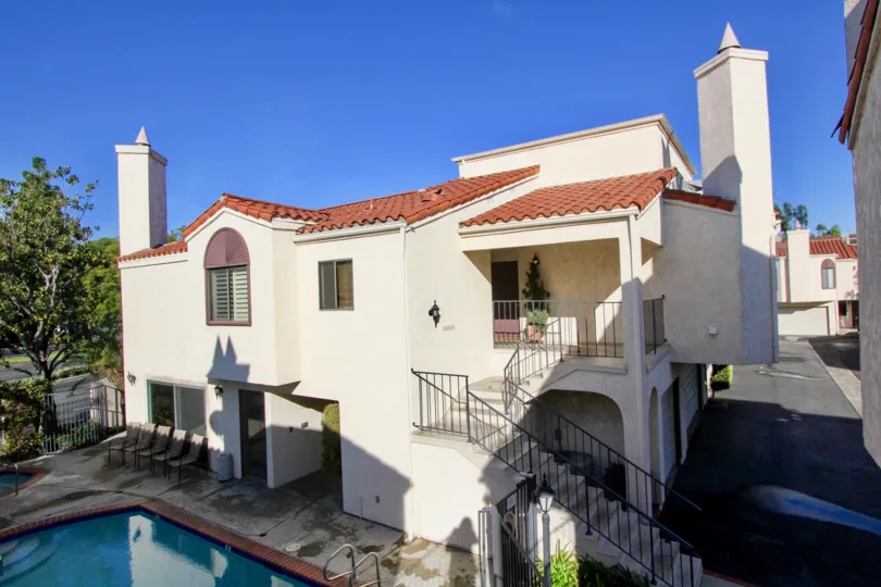 A multistory Spanish-style home with an included pool and set of garages located in the Villa Grande area of Garden Grove, California.