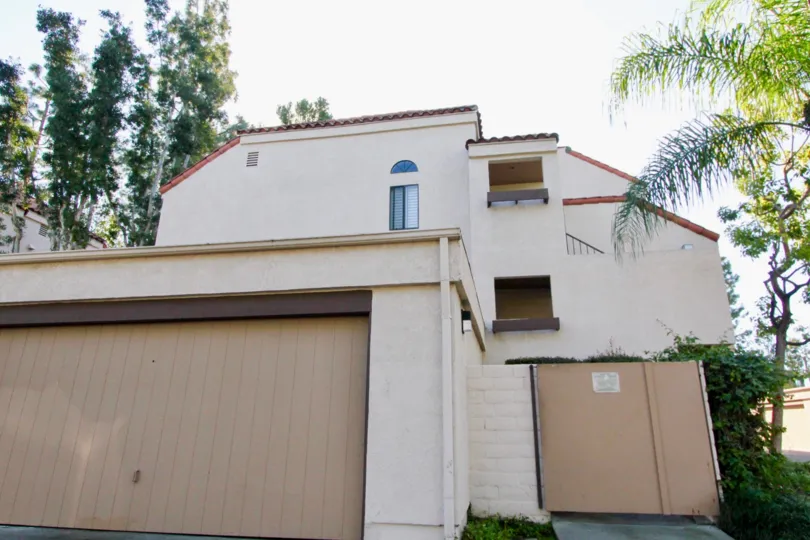 A garage sitting below a three story housing structure in Village Green in Garden Grove CA