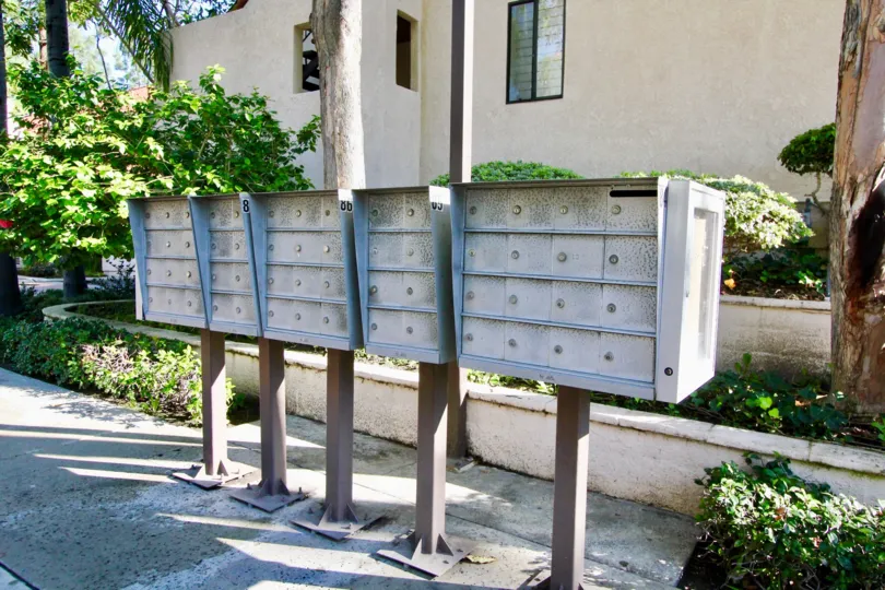 post boxes in line with housing and bushes in back