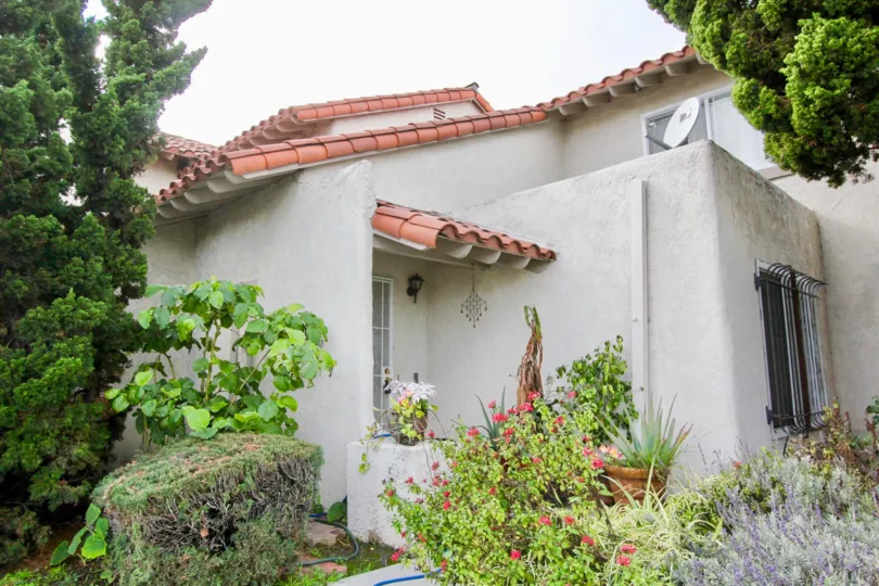 THIS PICTURE REPRESENTS THE HOME WITH BEAUTIFUL TREES, PLANTS WITH THE FLOWERS, AND THE DISH ALSO SHOWN IN THE CITY OF GARDEN GROVE