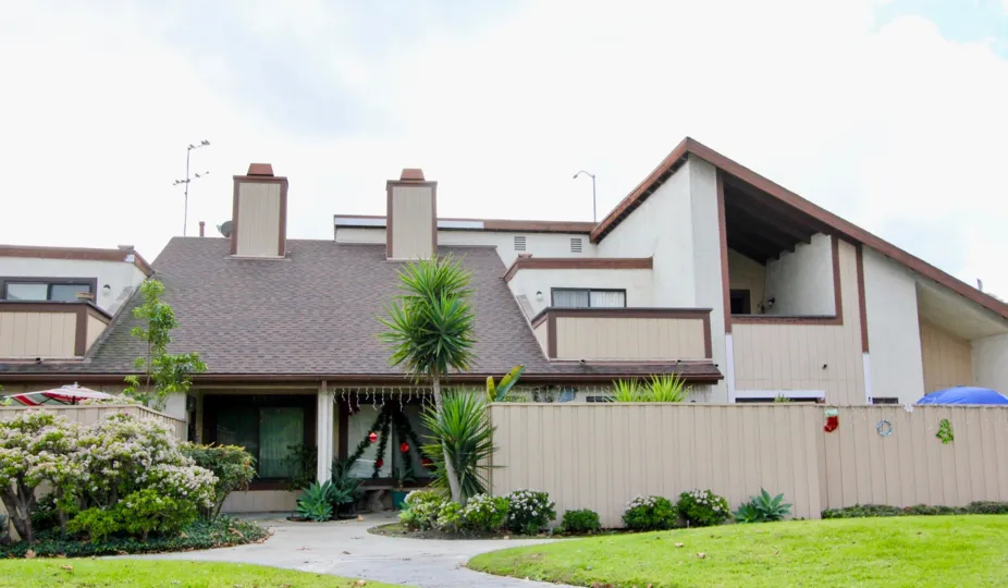 A street view of a home and landscaped yard on a sunny day at Yockey Condominiums