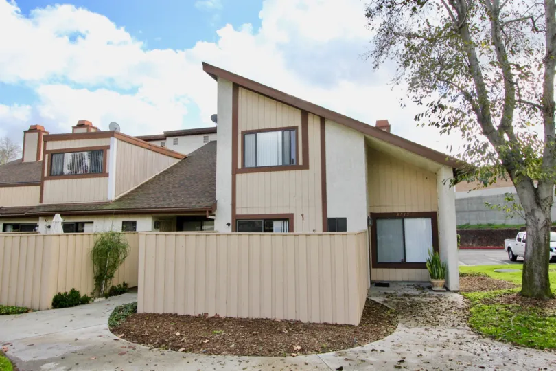 a pleasant day in the yockey condominiums with a house that has roofless top and one tree in right