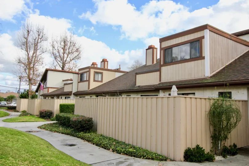 A row of condominiums with fenced-in backyards in the Yockey Condominiums area of Garden Grove, California.