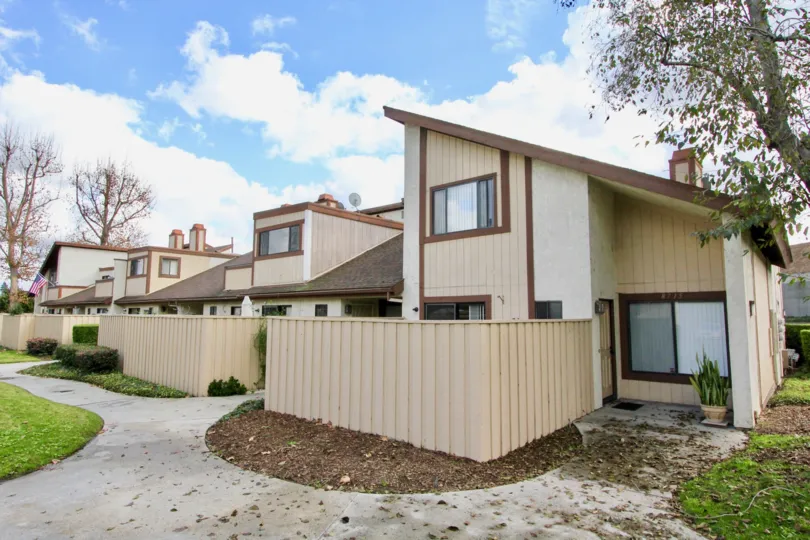 THE FLATS IN THE YOCKEY CONSOMINIUMS WITH THE DISH ANTENNA, FLOWER POT, TREES