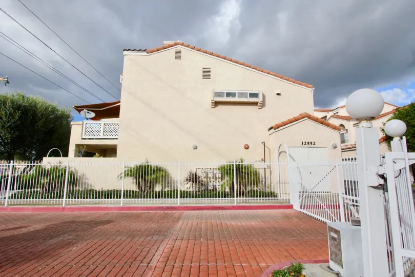 House at the Yorkshire Townhomes in Garden Grove with a Gate and trees