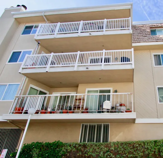 Bayport apartment with balconies and assorted furniture on a sunny day.