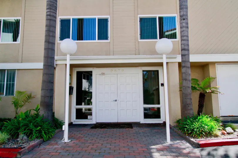 Entrance view of a villa with palm trees in Bayport of Huntington Beach