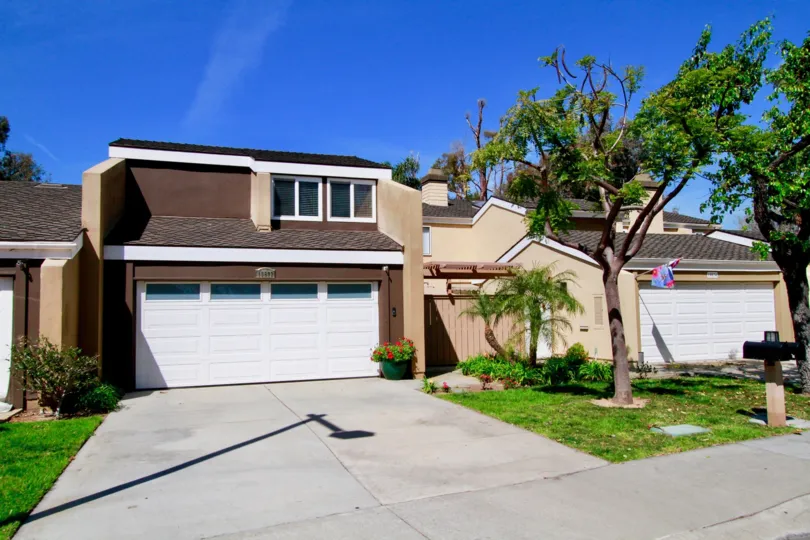 Beachwalk Huntington Beach California brown color building sky view near tree and grasses window attached