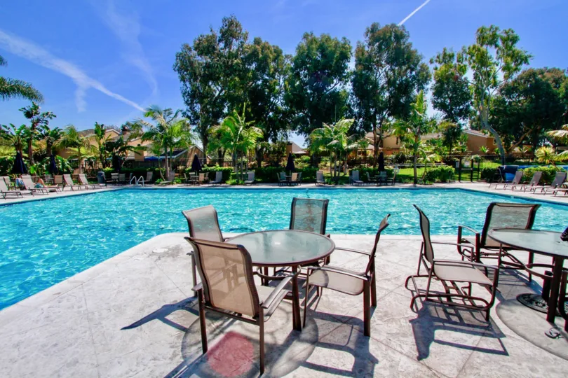 Lounge at the tables by the pool at the Beachwalk community