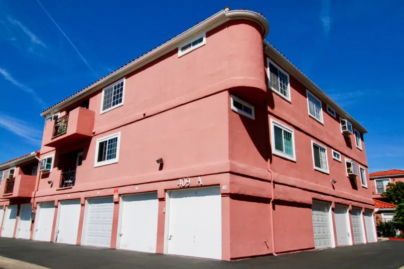 THE BUILDING AT THE CENTRE OF THE PLACE AND IT LOOKS LIKE RED COLOUR AT THE MORNING TIME