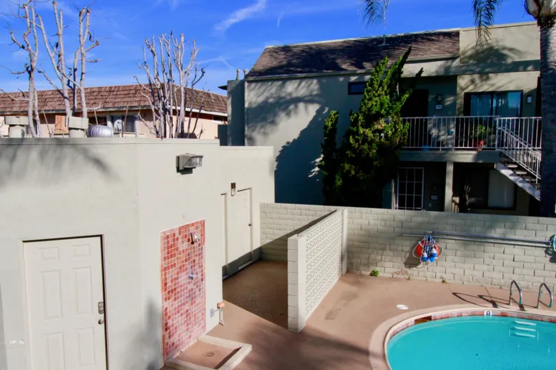 THE BUILDING WITH SWIMMING POOL LOOKS LIKE BEAUTIFUL AND THE POOL IS SMALL ONE SOME TREES ALSO AVAILABLE NEAR TO THE BUILDING AT THE MORNING TIME