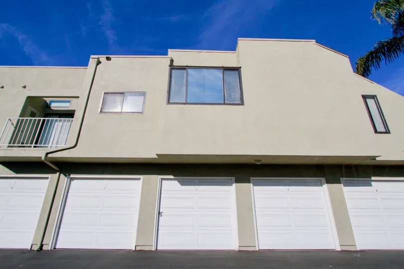 an apartment buliding of Bookstone with 5 garage doors and three windows