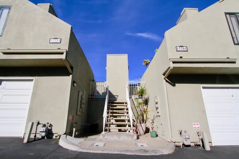 Staircase between Brookstone apartments with a balcony on a sunny day.