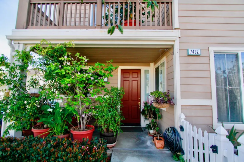 the small house with lot of flower pots in front of it in cape ann of huntington beach of california