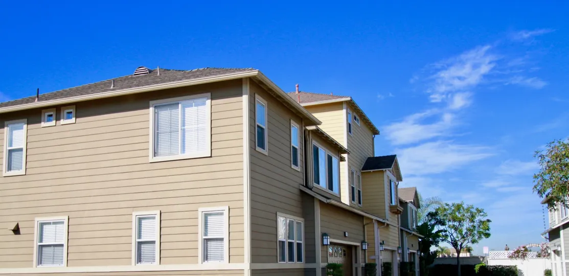 THE APARTMENTS WITH GOOD LOOKING WINDOWS AND IT MAY BE CONTAIN TWO FLOORS AND SOME TREES ALSO NEAR TO THE PLACE AT THE MORNING TIME