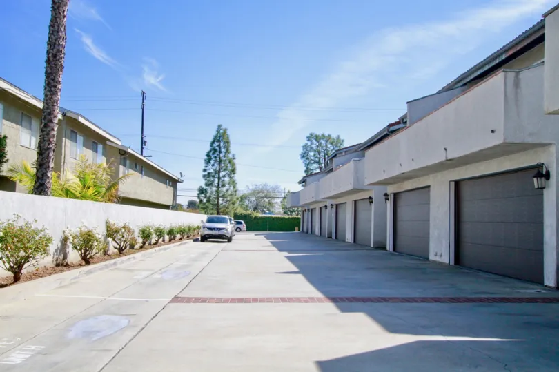 Crestview Estates street with garages and cars on a sunny day.