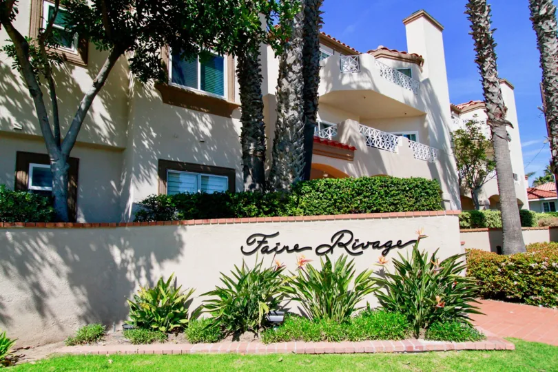 The front portion of Faire Rivage with lush greenary all around