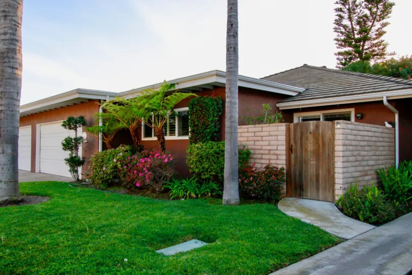A BUNGALOW LOOKS LIKE BEAUTIFUL AND SOME GARDENS IN FRONT OF THE HOUSE AND FLOWER PLANTS ALSO AVAILABLE AND A SMALL PATH ALSO THERE