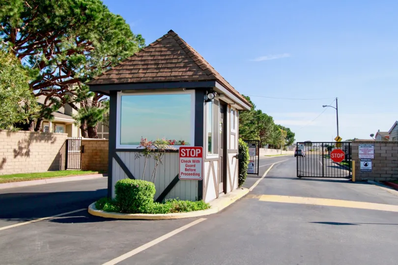 Gables Huntington Beach California bulding to road very long distance sequrity attached and gate near to lamp post sequrity room window attached back side tree