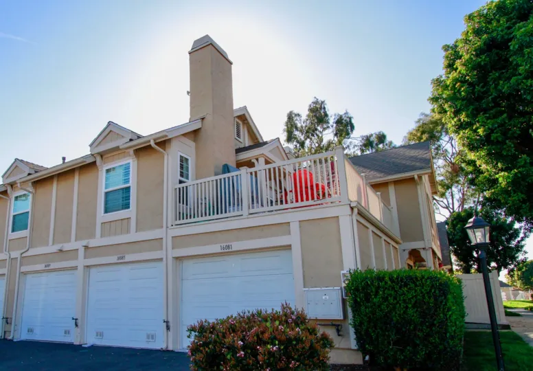 Excellent view of a villa with sunshine and terrace place with trees around in Gables of Huntington Beach
