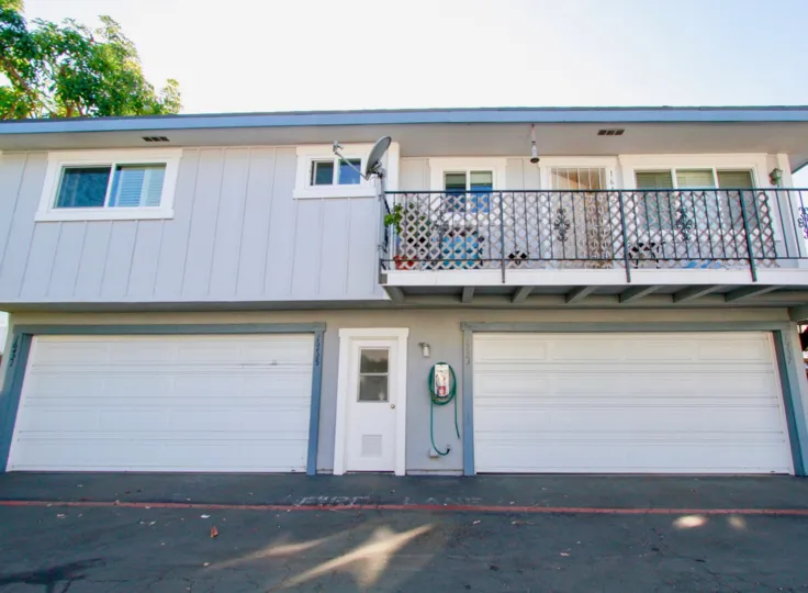 Harbor Heights Villas building with garages and a balconies on a sunny day.
