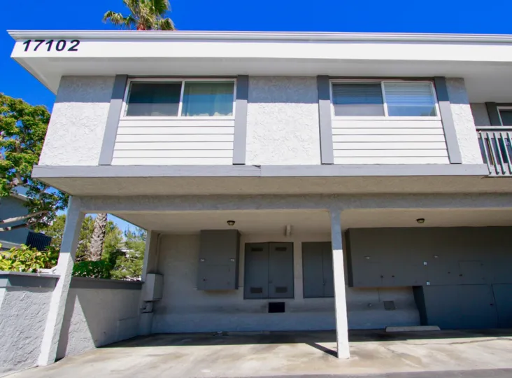 White residential building with number on top located in Harbour Pacific community.