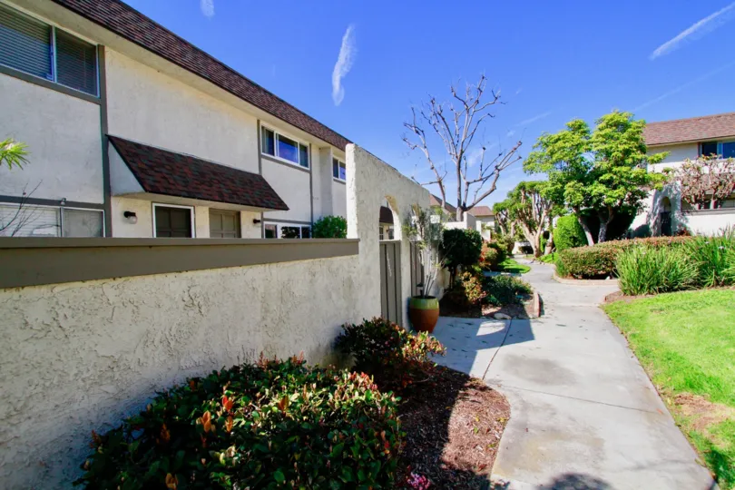 Villas Surrounded with beautiful lawn and trees on a sunny day in Harbour Village of Huntington Beach