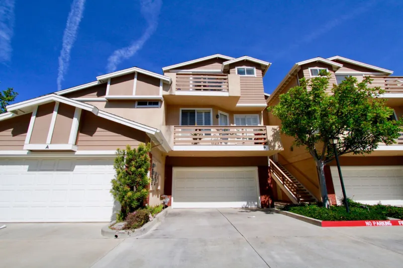 Holly Street Townhomes Huntington Beach California building light brown color paint window glass balcony attached front to big tree