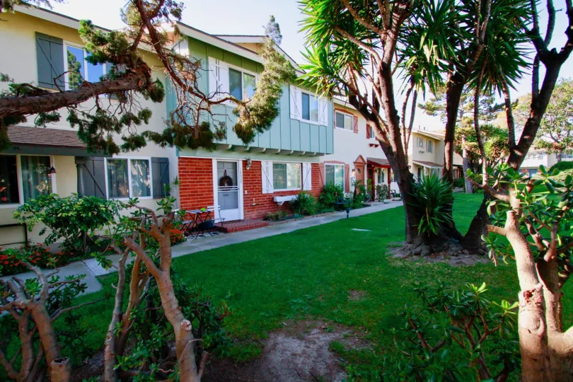 Nice view of palm trees and lawn besides villas in Huntington Bay of Huntington Beach