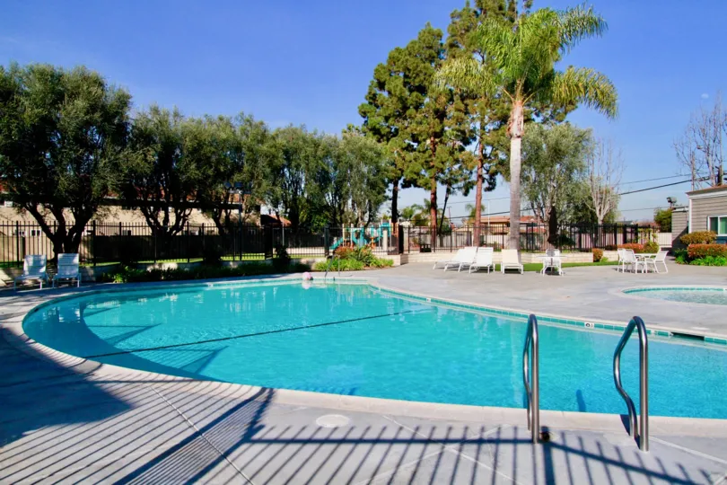 Huntington Continental Huntington Beach California building is not view biscuts color paint apply glass window attached side palm tree coverded front side big swmming pool and steps attached blue colour water
