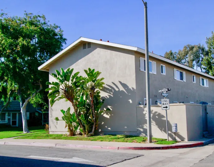 THE HOUSE WITH A GUEST ROOM AND A BOARD SIGN REPRESENTS ONE WAY AND A POST LINE ALSO IN FRONT OF THE PLACE AND SOME TREES ALSO NEAR TO THE HOUSE.