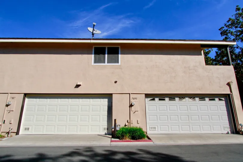 Two car garages with a window up top in Huntington Cove community.
