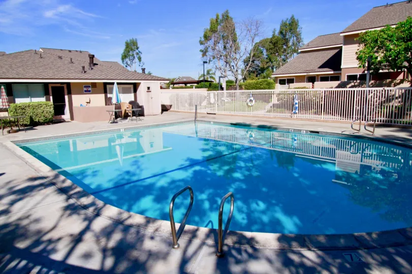 Blue coloured swimming pool between villas in Huntington Cove of Huntington Beach