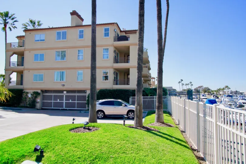 Huntington Harbour Bay Club Huntington Beach California building color light yellow ang glass attached car parking place very huge wall gate attached top very big pillar attached
