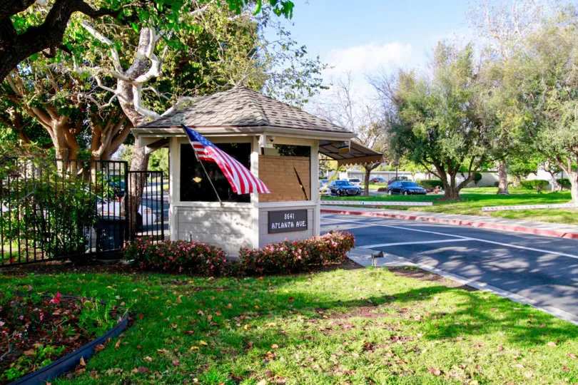 Huntington Landmark gazebo with a sign and flag on a sunny day.