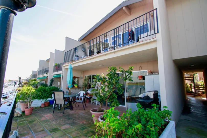 Huntington Marina Huntington Beach California building light biscuts color paint front glass window balcony chair table flower pot attached