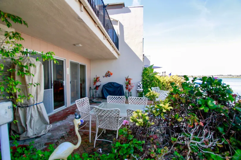 garden with the tea table in front of the house which is locate in huntington marina of humtington beach, california