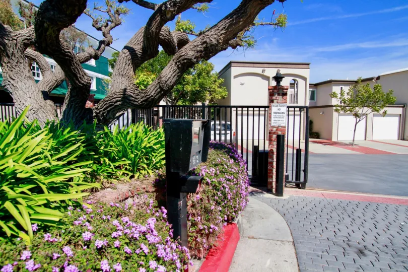 The front portion of Huntington Marina with gates open and flowering plants at entrance