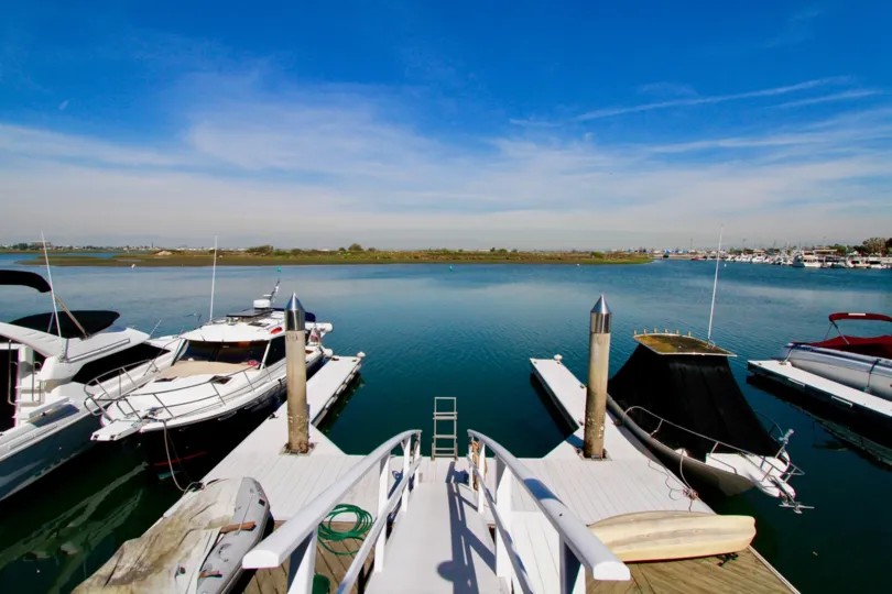 A beautiful view of the water and boats docked in the Huntington Marina.