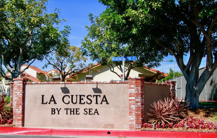 In a sunny day a brick designed LA cuesta by the sea in the city of Huntington Beach, CA with trees but without any person.