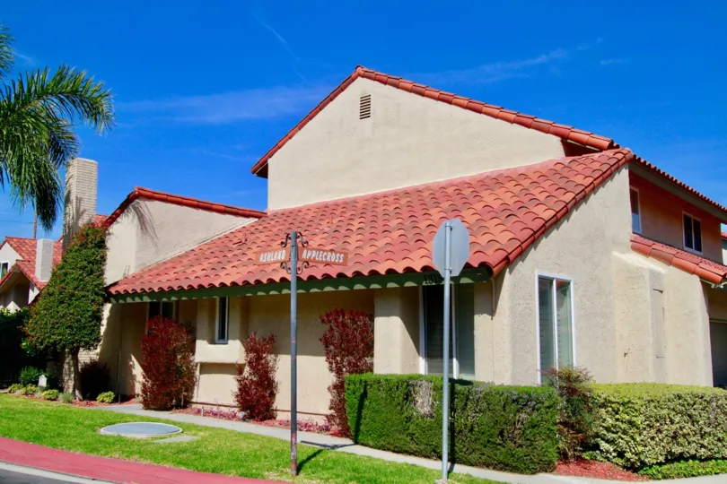the house with road sign in in red shade of topping which is locate in huntington beach of california
