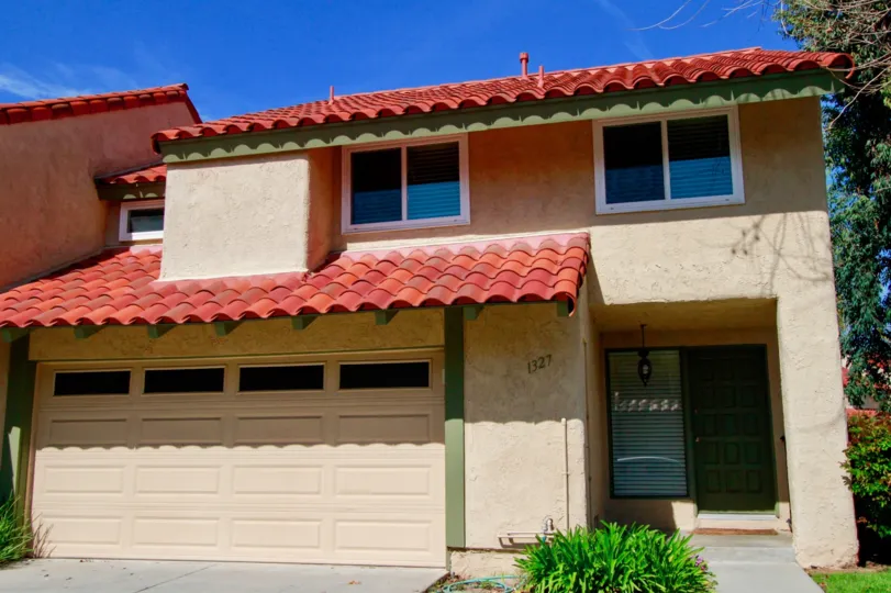 A bright red clay roof on La Cuesta Racquet Club community