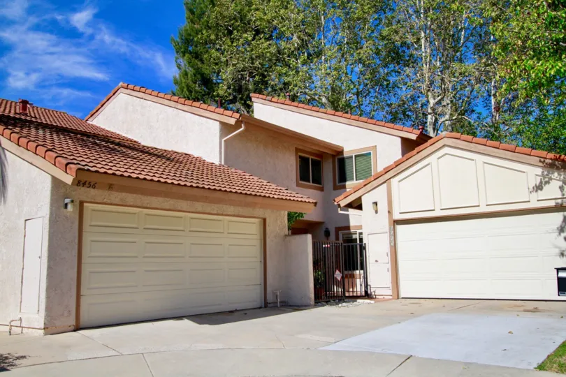 Home with multiple garages, two stories located in La Cuesta Tennis Club community in Huntington Beach, CA