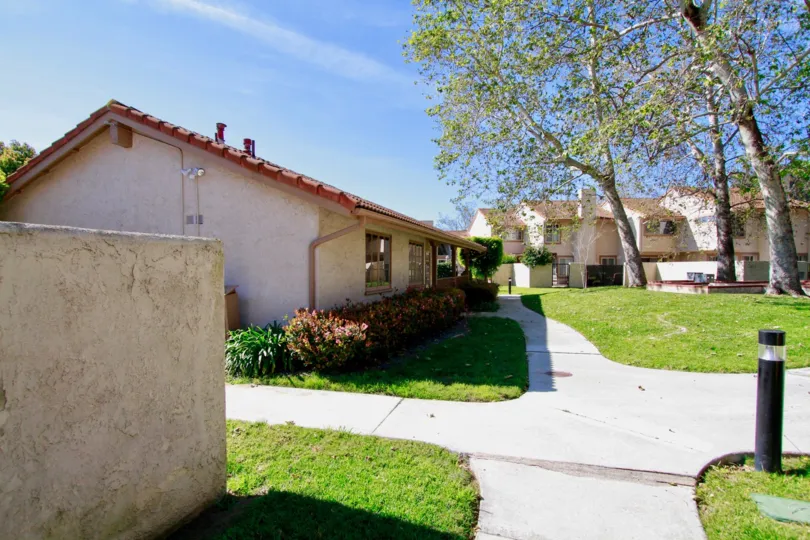 Nice view of Lawn with trees front of villa in La Cuesta Tennis Club of Huntington Beach