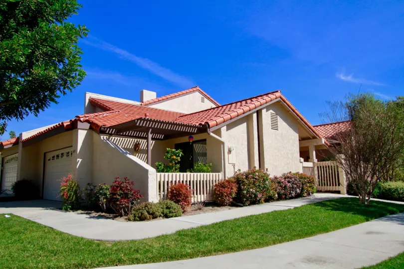 Landmark Yorktown home with a patio and garages on a sunny day.