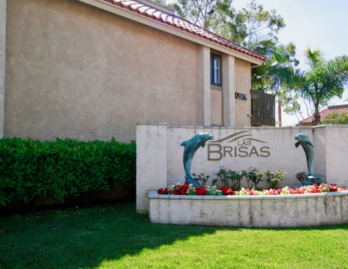 Nice Name board of villa with two dolphins and surrounded with trees in Las Brisas of Huntington Beach