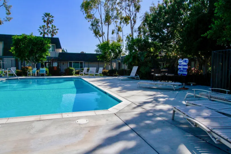 Beautiful cool swimming pool with sitting place and trees around in Mariners Cove West Huntington Beach