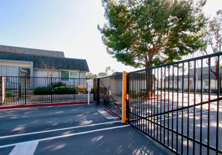 The gated entrace of Mariners Cove West on a warm, sunny day.
