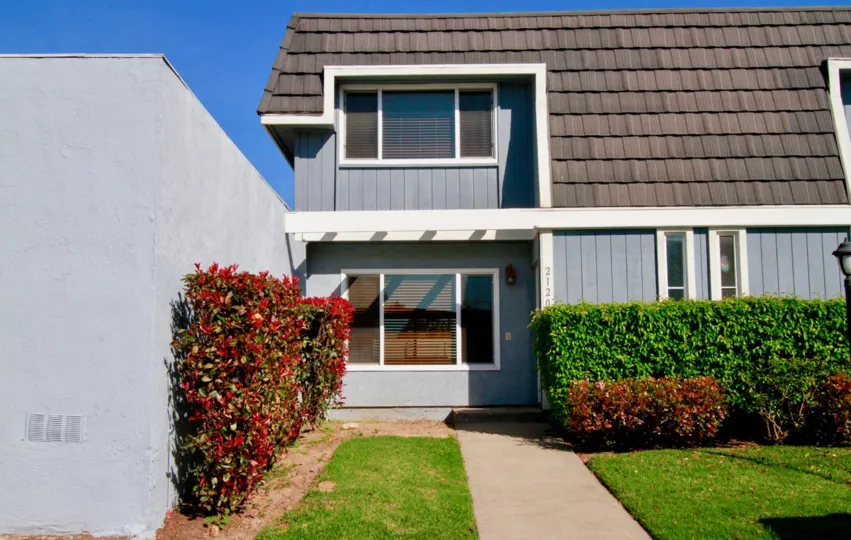 Mariners Cove Huntington Beach California building light gray color paint front glass window attached bricks colour brown